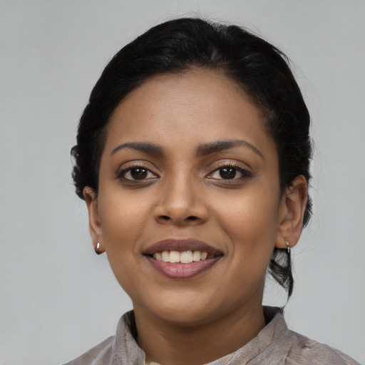 Joyful latino young-adult female with short  black hair and brown eyes