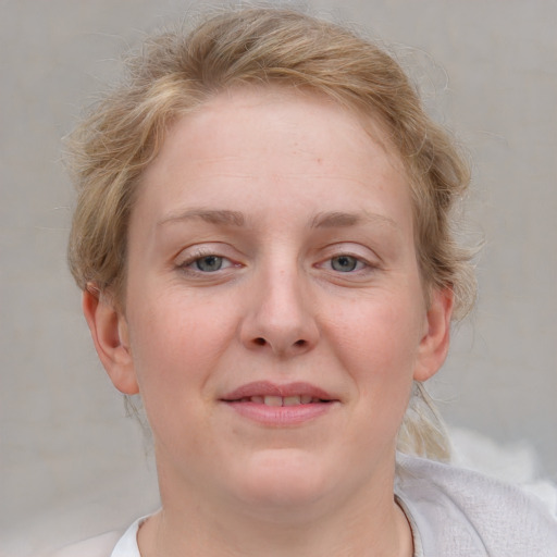 Joyful white young-adult female with medium  brown hair and blue eyes