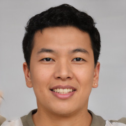 Joyful asian young-adult male with short  brown hair and brown eyes