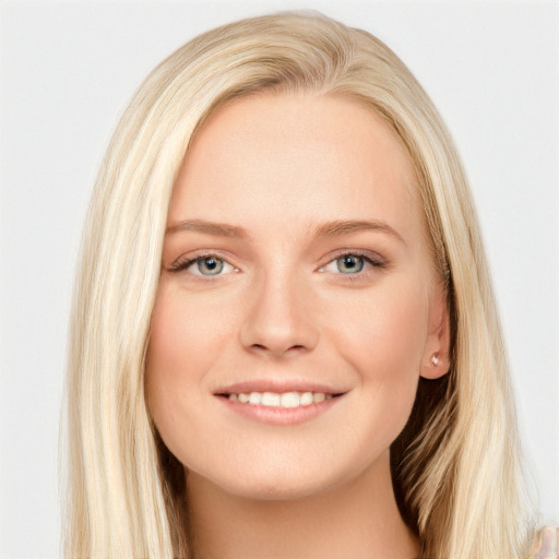 Joyful white young-adult female with long  brown hair and blue eyes