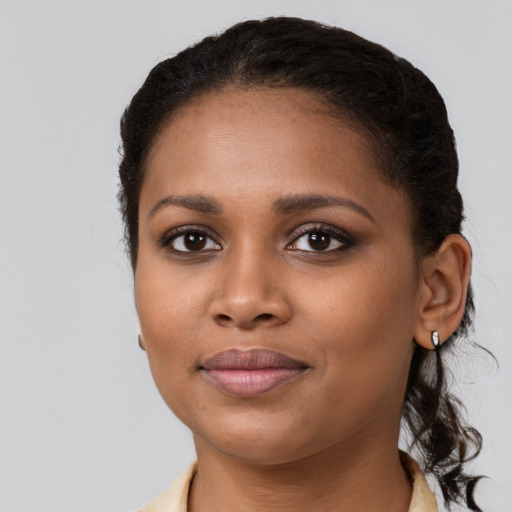 Joyful black young-adult female with medium  brown hair and brown eyes