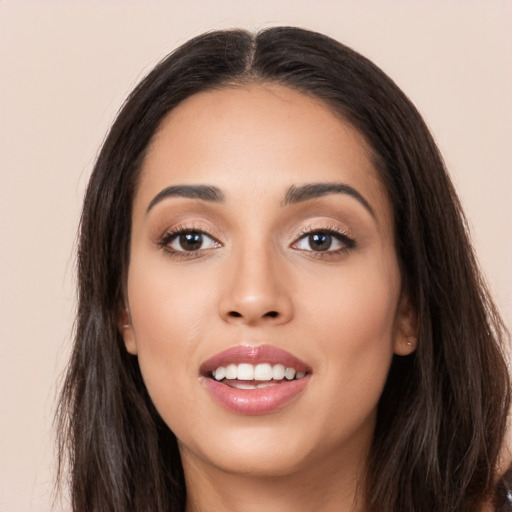 Joyful white young-adult female with long  black hair and brown eyes