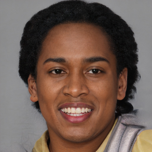 Joyful black young-adult female with short  black hair and brown eyes