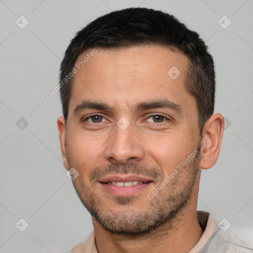 Joyful white young-adult male with short  black hair and brown eyes