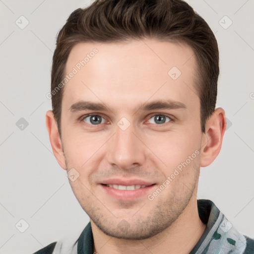 Joyful white young-adult male with short  brown hair and grey eyes