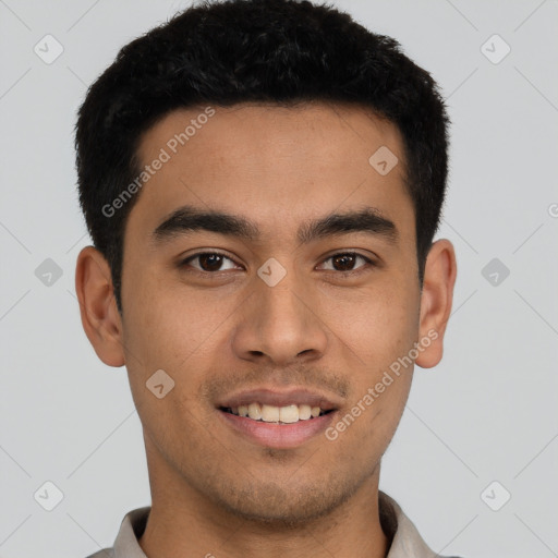 Joyful latino young-adult male with short  black hair and brown eyes