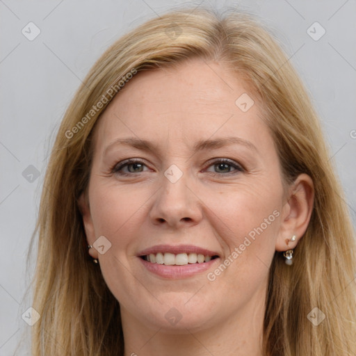 Joyful white adult female with long  brown hair and grey eyes