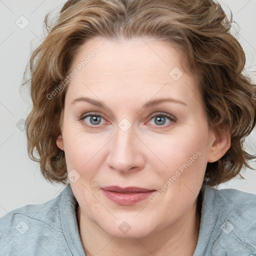 Joyful white adult female with medium  brown hair and blue eyes