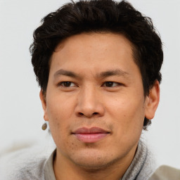 Joyful asian adult male with short  brown hair and brown eyes