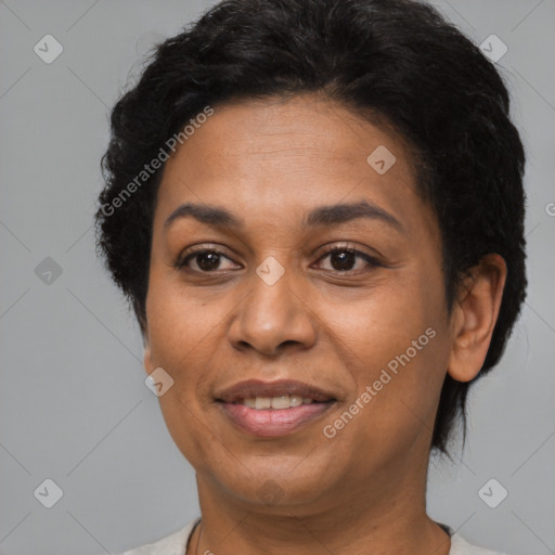 Joyful latino adult female with short  brown hair and brown eyes