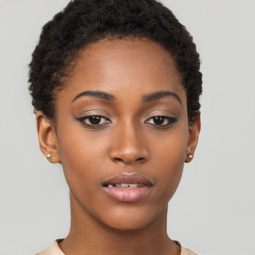 Joyful black young-adult female with short  brown hair and brown eyes