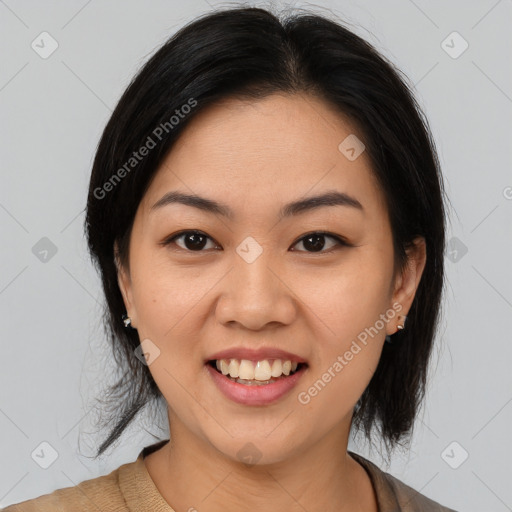 Joyful asian young-adult female with medium  black hair and brown eyes