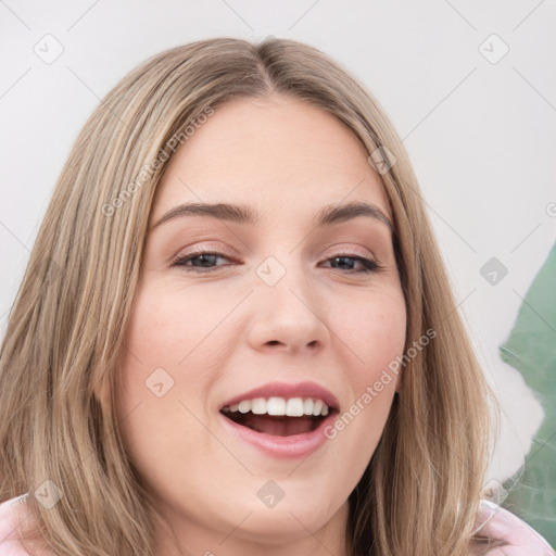 Joyful white young-adult female with long  brown hair and brown eyes