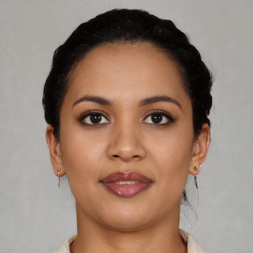 Joyful latino young-adult female with short  black hair and brown eyes