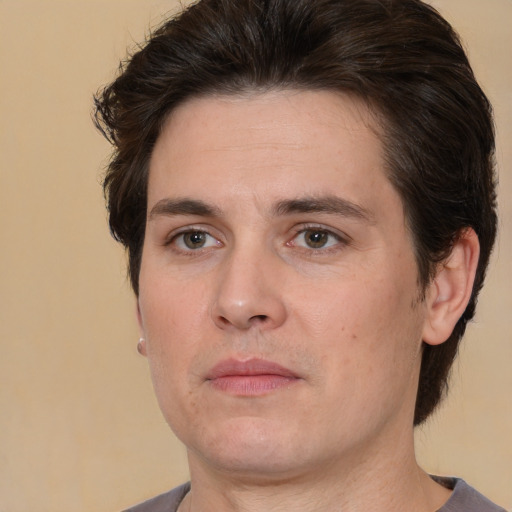 Joyful white young-adult male with medium  brown hair and brown eyes