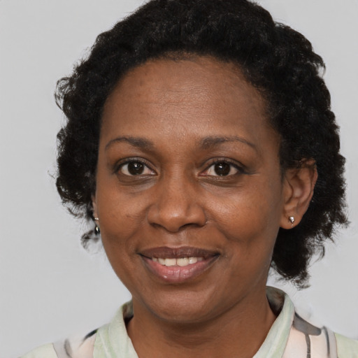 Joyful black adult female with short  brown hair and brown eyes