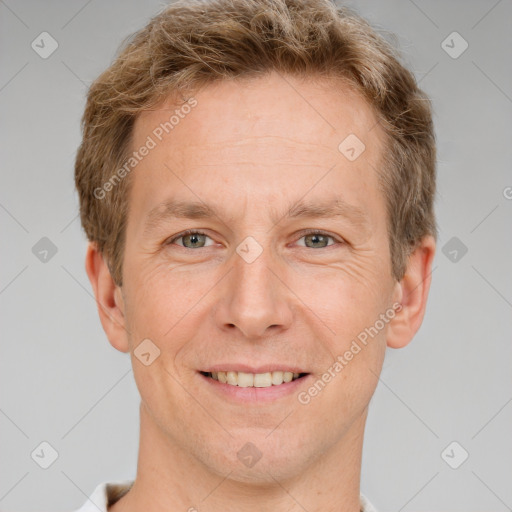 Joyful white adult male with short  brown hair and grey eyes