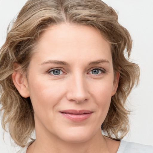 Joyful white young-adult female with medium  brown hair and blue eyes