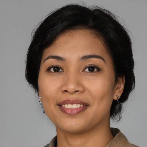 Joyful latino young-adult female with medium  black hair and brown eyes