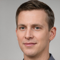 Joyful white adult male with short  brown hair and grey eyes