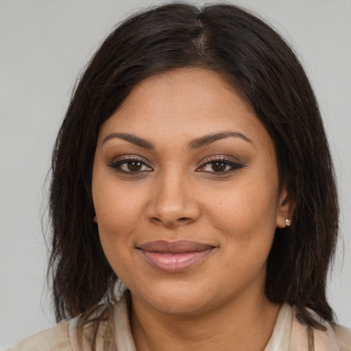 Joyful latino young-adult female with medium  brown hair and brown eyes