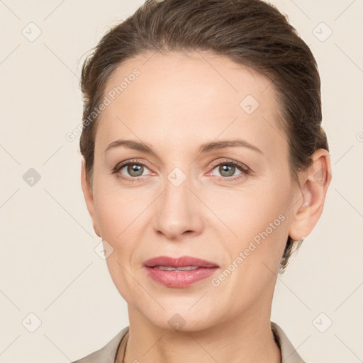 Joyful white adult female with short  brown hair and grey eyes