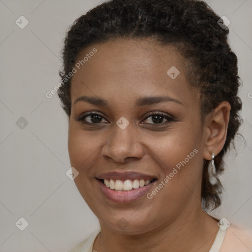 Joyful black young-adult female with short  brown hair and brown eyes