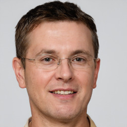 Joyful white adult male with short  brown hair and grey eyes