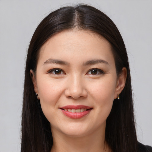 Joyful white young-adult female with long  brown hair and brown eyes