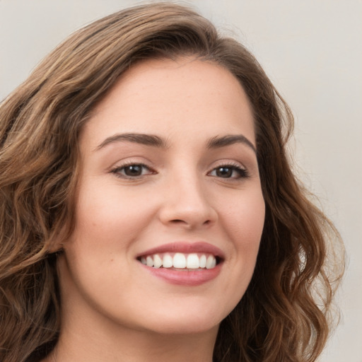 Joyful white young-adult female with long  brown hair and green eyes