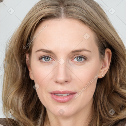 Joyful white young-adult female with long  brown hair and blue eyes