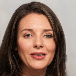 Joyful white adult female with long  brown hair and brown eyes