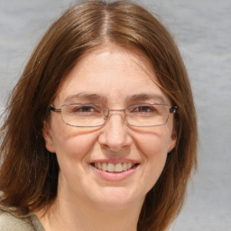 Joyful white adult female with medium  brown hair and brown eyes