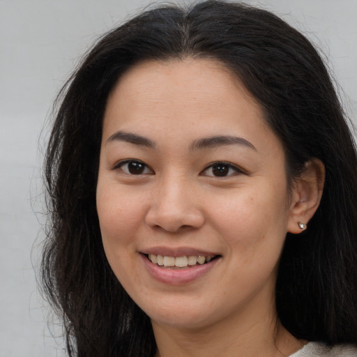 Joyful white young-adult female with long  brown hair and brown eyes