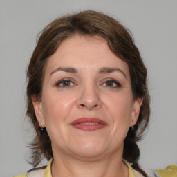 Joyful white adult female with medium  brown hair and brown eyes