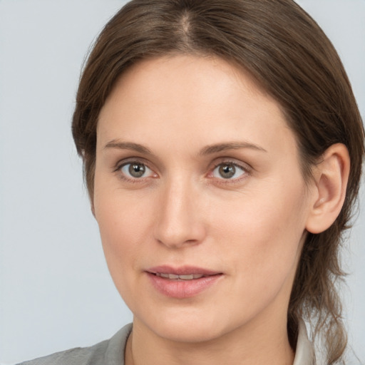 Joyful white young-adult female with medium  brown hair and grey eyes