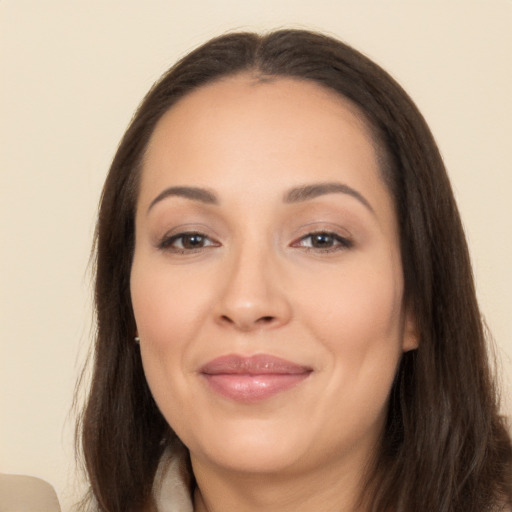 Joyful white young-adult female with long  brown hair and brown eyes