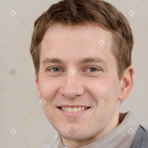 Joyful white adult male with short  brown hair and grey eyes