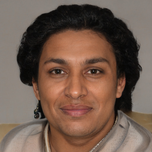 Joyful black adult male with short  brown hair and brown eyes
