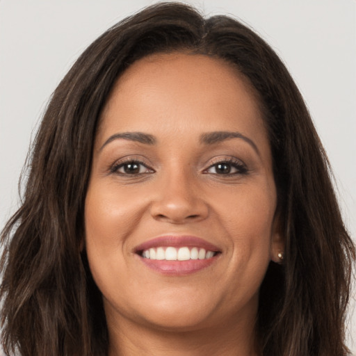 Joyful white young-adult female with long  brown hair and brown eyes