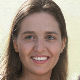 Joyful white young-adult female with long  brown hair and green eyes