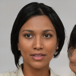 Joyful asian young-adult female with medium  black hair and brown eyes