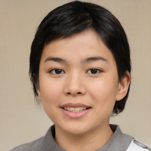Joyful asian young-adult female with medium  black hair and brown eyes