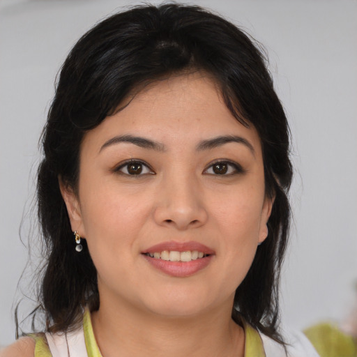 Joyful asian young-adult female with medium  brown hair and brown eyes
