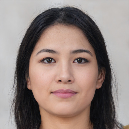 Joyful asian young-adult female with long  brown hair and brown eyes