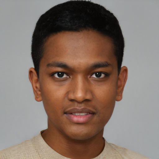 Joyful black young-adult male with short  black hair and brown eyes