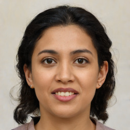 Joyful latino young-adult female with medium  brown hair and brown eyes