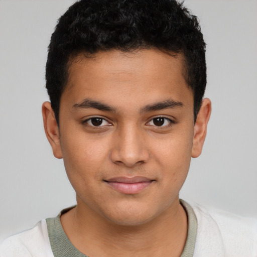 Joyful latino child male with short  brown hair and brown eyes