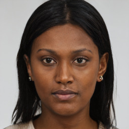 Neutral black young-adult female with long  brown hair and brown eyes