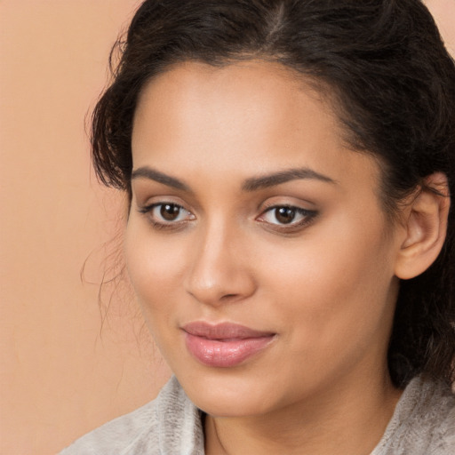 Joyful latino young-adult female with medium  brown hair and brown eyes